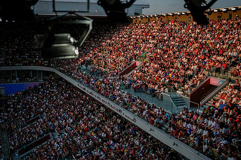 Attendees watch the match between Novak Djokovic and Lorenzo Musetti